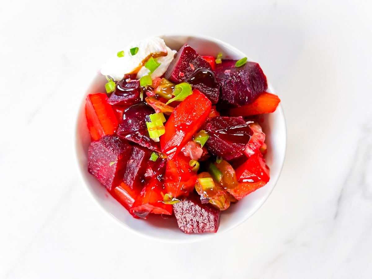 Beet salad in a bowl with goat cheese.