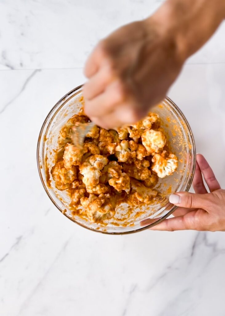 Stirring the batter into the cauliflower