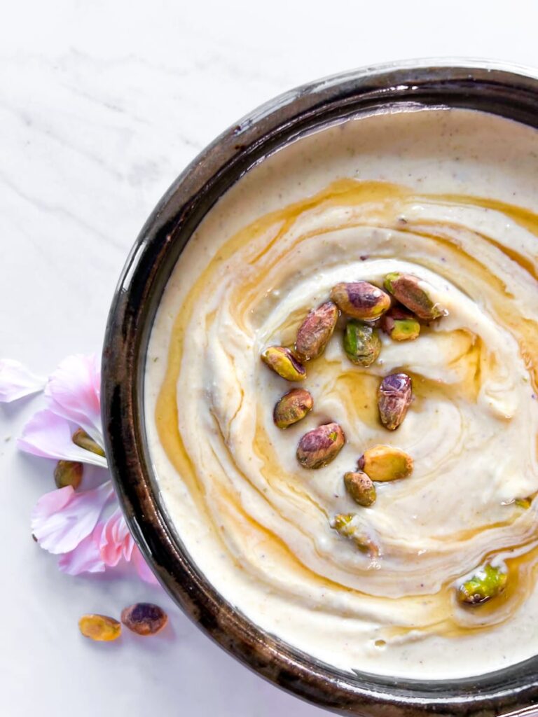 Whipped feta in a bowl with flowers.