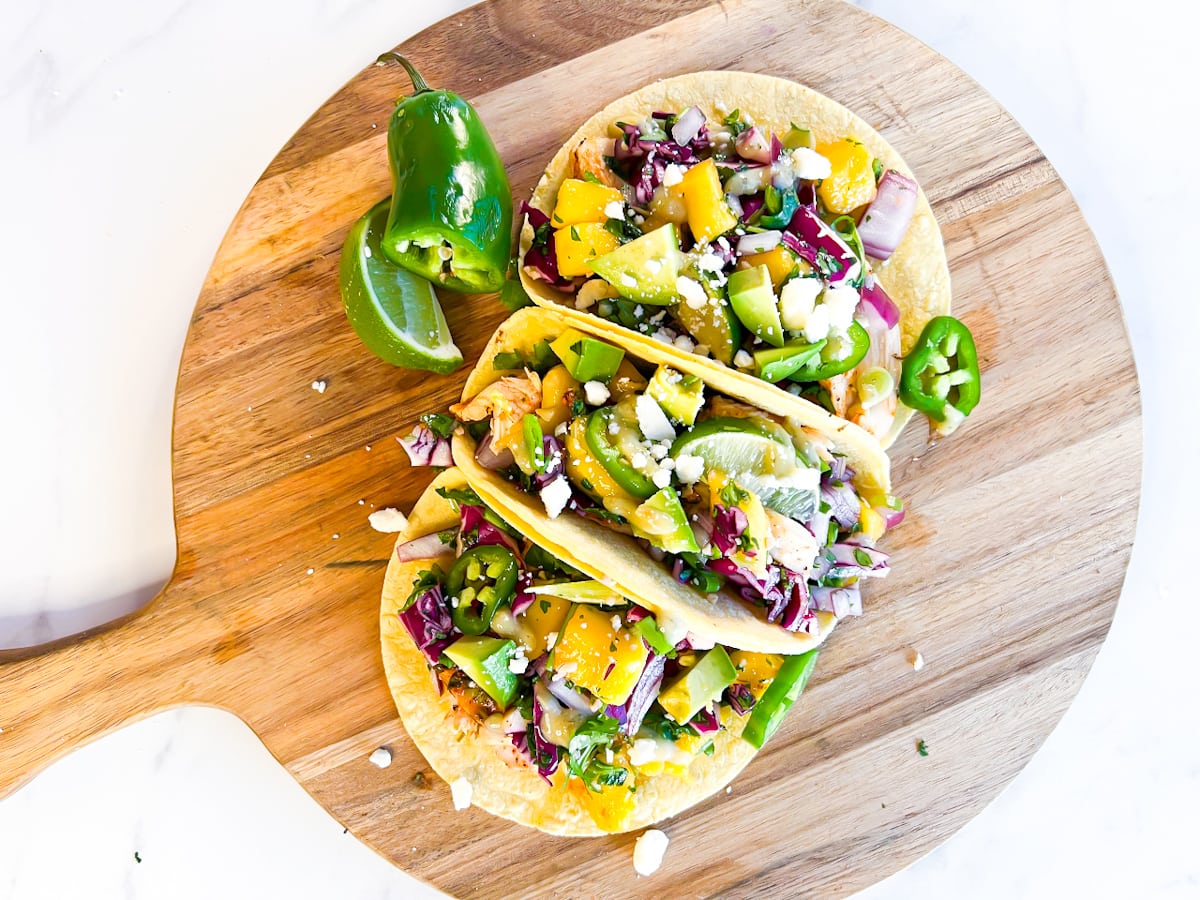 Chicken tacos on a cutting board.