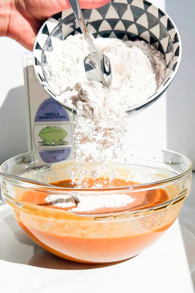 Flour being poured in the mixture.