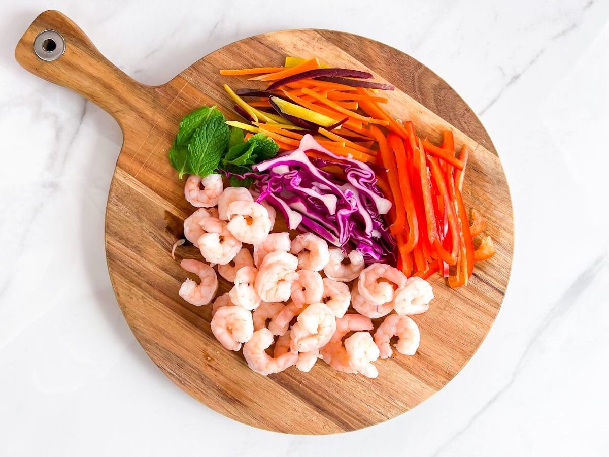 Spring roll ingredients on a cutting board.