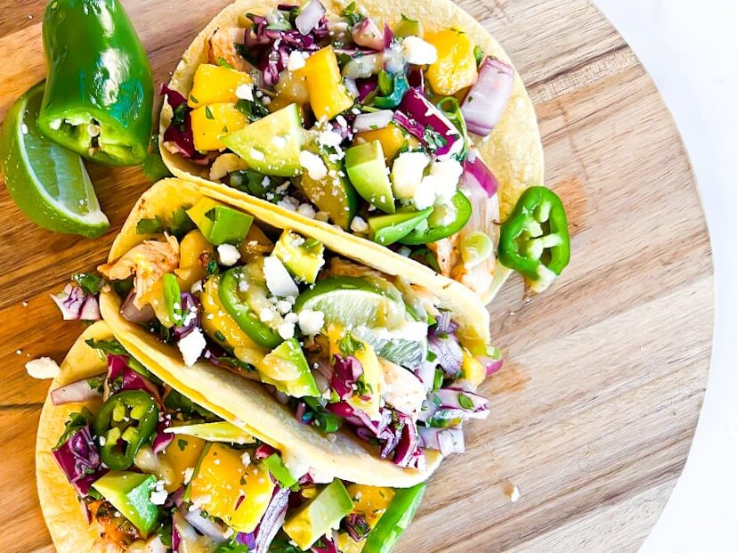 Chicken tacos on a cutting board.